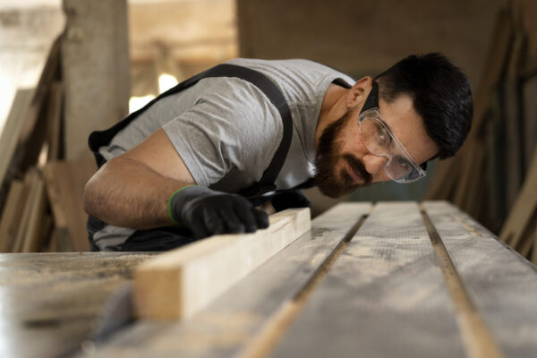 carpenter-cutting-mdf-board-inside-workshop