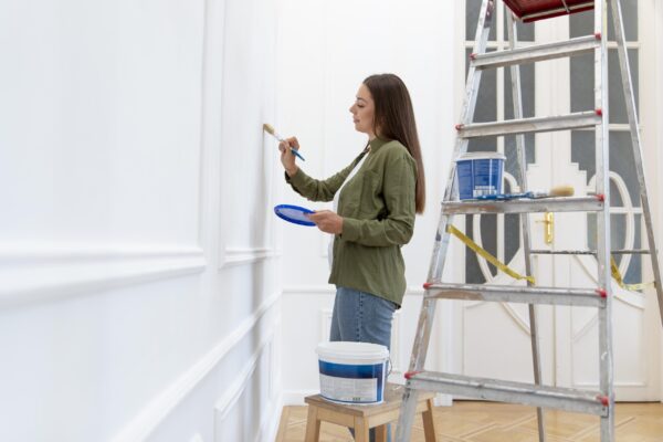 medium-shot-woman-painting-wall-home