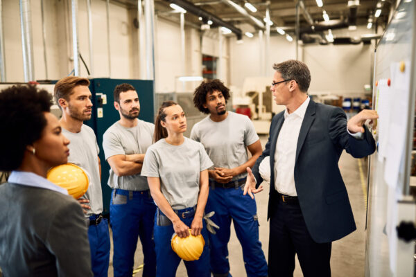 Company manager presenting business strategy to group of workers Certificate III workplace safety- Noble training group