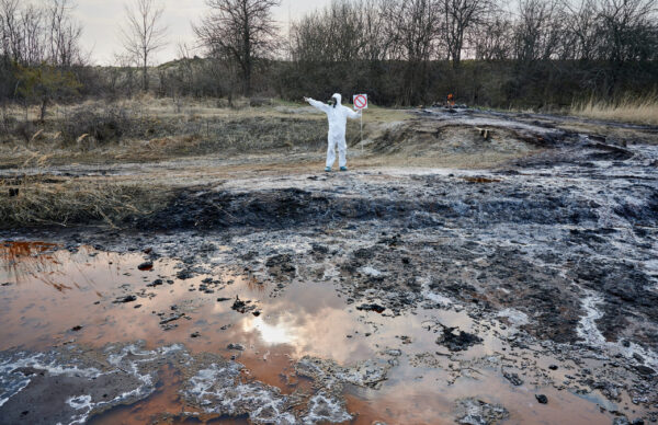 Scientist exploring territory, emission area, polluted water, man in protective suit Surface Extraction Ops- noble training group