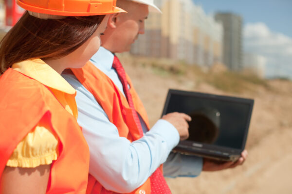 architects works in front of building site