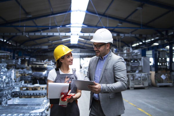 Manager supervisor and worker discussing about production results and new strategy in factory industrial hall. how to renew plant operator license - Noble training group
